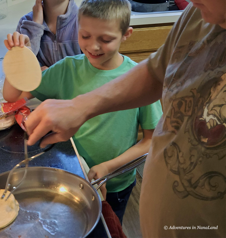 Boy helping grandpa to cook tortillas - Grandma Camp Weekend - Adventures in NanaLand