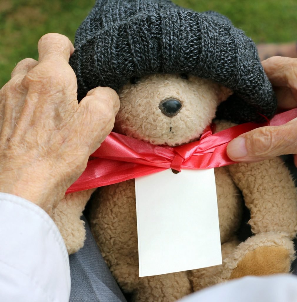 teddy bear being held by elderly hands - Adventures in NanaLand